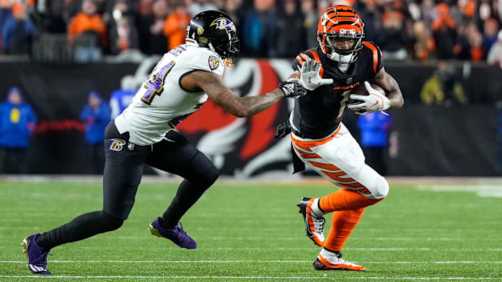 Cincinnati Bengals wide receiver Ja'Marr Chase (1) stiff arms Baltimore Ravens cornerback Marcus