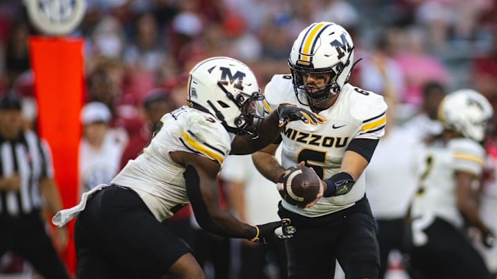 Oct 26, 2024; Tuscaloosa, Alabama, USA;  Missouri Tigers quarterback Drew Pyne (6) hands off to running back Marcus Carroll (9) against the Alabama Crimson Tide during the fourth quarter at Bryant-Denny Stadium. Mandatory Credit: Will McLelland-Imagn Images
