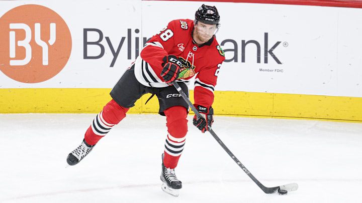 Jan 12, 2026; Chicago, Illinois, USA; Chicago Blackhawks left wing Andre Burakovsky (28) looks to pass the puck against the Edmonton Oilers during the second period at United Center. Mandatory Credit: Kamil Krzaczynski-Imagn Images
