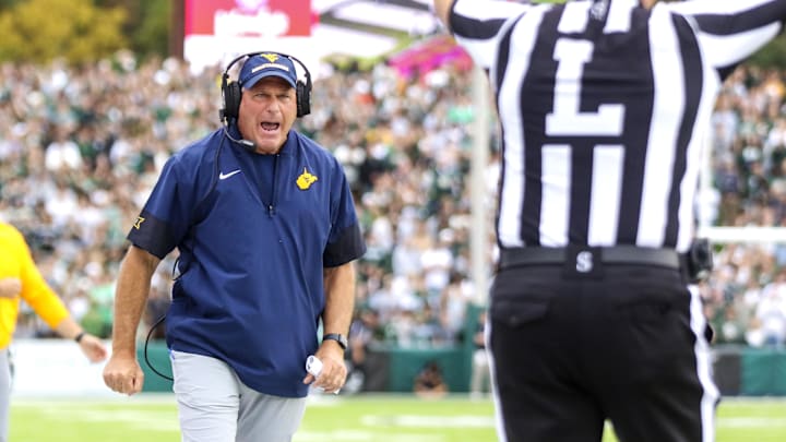 Sep 6, 2025; Athens, Ohio, USA; West Virginia Mountaineers head coach Rich Rodriguez calls a timeout during the second quarter against the Ohio Bobcats at Peden Stadium. Mandatory Credit: Ben Queen-Imagn Images