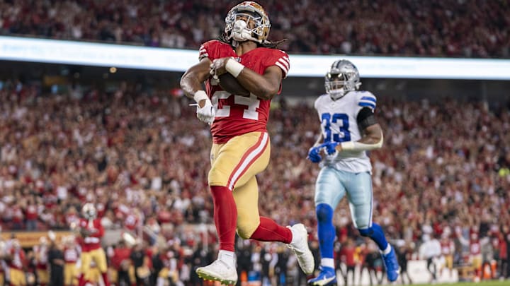 October 8, 2023; Santa Clara, California, USA; San Francisco 49ers running back Jordan Mason (24) scores a touchdown against Dallas Cowboys linebacker Damone Clark (33) during the fourth quarter at Levi's Stadium. Mandatory Credit: Kyle Terada-Imagn Images