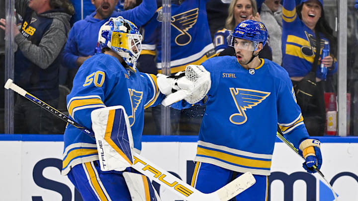 Mar 16, 2024; St. Louis, Missouri, USA;  St. Louis Blues center Jordan Kyrou (25) celebrates with goaltender Jordan Binnington (50) after the Blues defeated the Minnesota Wild in shoot outs at Enterprise Center. Mandatory Credit: Jeff Curry-Imagn Images