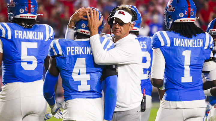 Nov 15, 2025; Oxford, Mississippi, USA; Mississippi Rebels head coach Lane Kiffin embraces linebacker Suntarine Perkins (4) during the second half against the Florida Gators at Vaught-Hemingway Stadium. Mandatory Credit: Petre Thomas-Imagn Images
