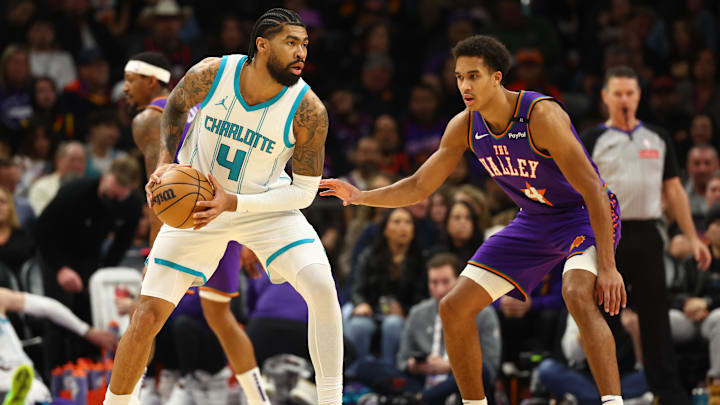 Jan 12, 2025; Phoenix, Arizona, USA; Charlotte Hornets center Nick Richards (left) against Phoenix Suns center Oso Ighodaro at Footprint Center. Mandatory Credit: Mark J. Rebilas-Imagn Images