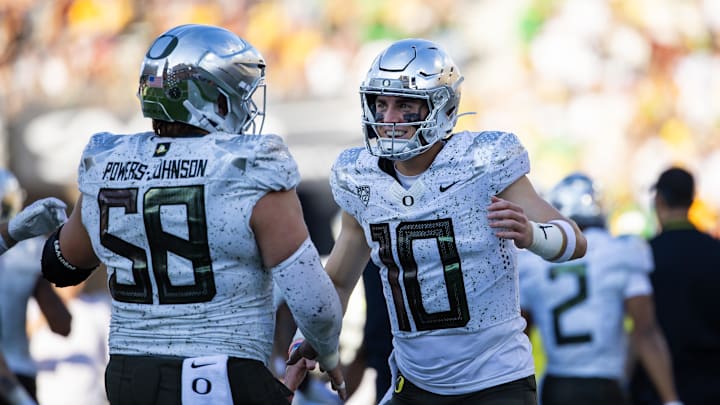 Nov 18, 2023; Tempe, Arizona, USA; Oregon Ducks quarterback Bo Nix (10) celebrates a touchdown with center Jackson Powers-Johnson (58).