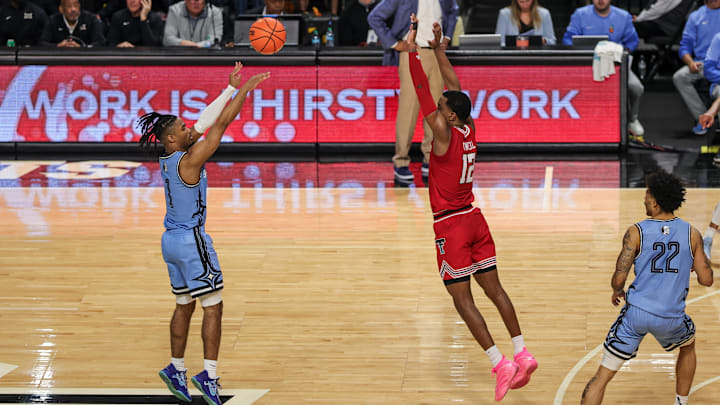 Jan 31, 2026; Orlando, Florida, USA; UCF Knights guard Themus Fulks (1) shoots against Texas Tech Red Raiders forward Donovan Atwell (12) during the second half at Addition Financial Arena. Mandatory Credit: Mike Watters-Imagn Images Jan 31, 2026; Orlando, Florida, USA; UCF Knights guard Themus Fulks (1) shoots against Texas Tech Red Raiders forward Donovan Atwell (12) during the second half at Addition Financial Arena. Mandatory Credit: Mike Watters-Imagn Images