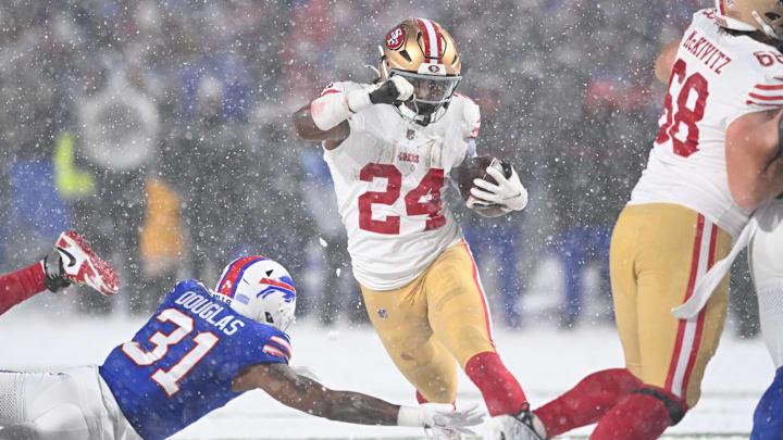 Dec 1, 2024; Orchard Park, New York, USA; San Francisco 49ers running back Jordan Mason (24) avoids a tackle by Buffalo Bills cornerback Rasul Douglas (31) in the third quarter at Highmark Stadium. Mandatory Credit: Mark Konezny-Imagn Images Dec 1, 2024; Orchard Park, New York, USA; San Francisco 49ers running back Jordan Mason (24) avoids a tackle by Buffalo Bills cornerback Rasul Douglas (31) in the third quarter at Highmark Stadium. Mandatory Credit: Mark Konezny-Imagn Images