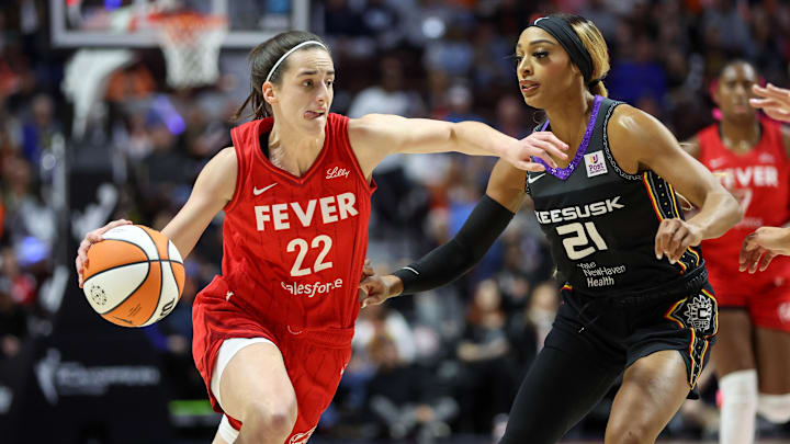 Sep 25, 2024; Uncasville, Connecticut, USA; Indiana Fever guard Caitlin Clark (22) drives to the basket defended by Connecticut Sun guard DiJonai Carrington (21) during the first half during game two of the first round of the 2024 WNBA Playoffs at Mohegan Sun Arena. Mandatory Credit: Paul Rutherford-Imagn Images