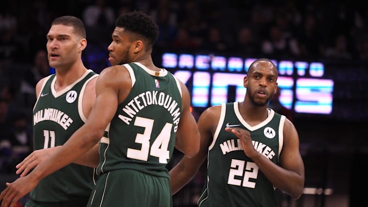 Mar 16, 2022; Sacramento, California, USA; Milwaukee Bucks forward Khris Middleton (22) celebrates with center Brook Lopez (11) and forward Giannis Antetokounmpo (34) after a play against the Sacramento Kings during the fourth quarter at Golden 1 Center. Mandatory Credit: Kelley L Cox-Imagn Images