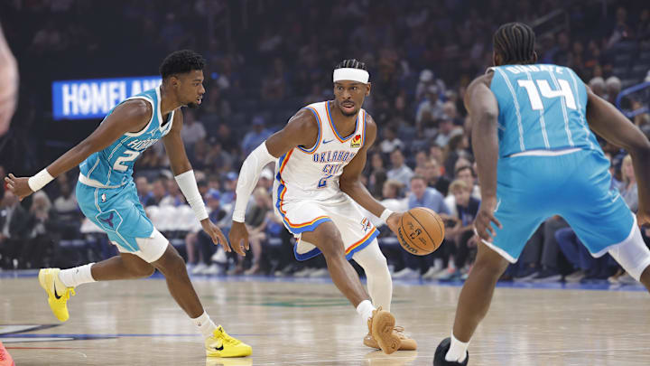 Oct 9, 2025; Oklahoma City, Oklahoma, USA; Oklahoma City Thunder guard Shai Gilgeous-Alexander (2) drives between Charlotte Hornets forward Brandon Miller (24) and forward Moussa Diabaté (14) during the 1st quarter of a game between the Charlotte Hornets and the Oklahoma City Thunder at Paycom Center. Mandatory Credit: Alonzo Adams-Imagn Images