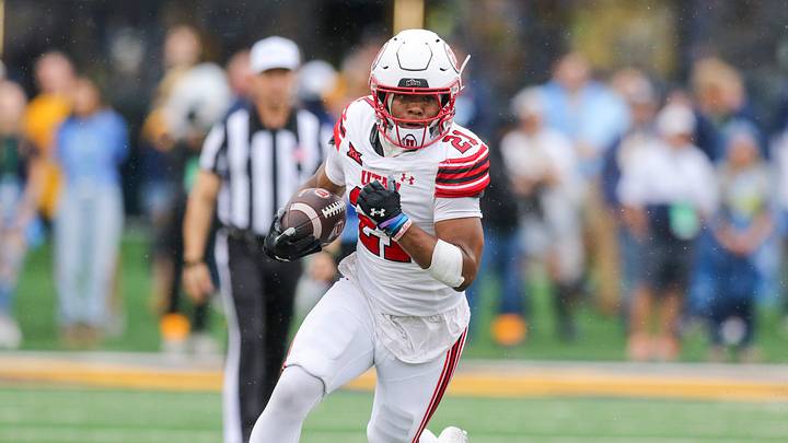 Sep 27, 2025; Morgantown, West Virginia, USA; Utah Utes running back NaQuari Rogers (21) runs the ball during the first quarter against the West Virginia Mountaineers at Milan Puskar Stadium. Mandatory Credit: Ben Queen-Imagn Images