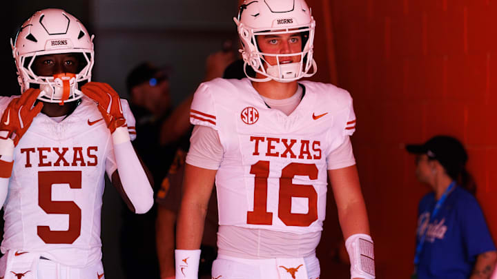 Oct 4, 2025; Gainesville, Florida, USA; Texas Longhorns quarterback Arch Manning (16) walks out of the tunnel with Texas Longhorns running back Quintrevion Wisner (5).