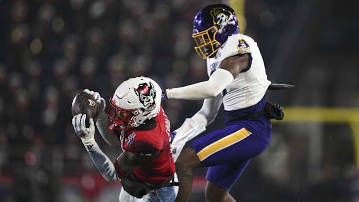 Dec 28, 2024; Annapolis, MD, USA;  North Carolina State Wolfpack cornerback Tamarcus Cooley (15) intercepts a pass during the second half of the  Go Bowling Military Bowl against the East Carolina Pirates at Navy-Marine Corps Memorial Stadium. Mandatory Credit: Tommy Gilligan-Imagn Images