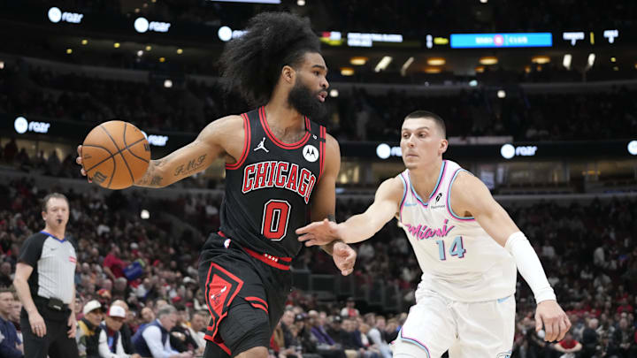 Apr 9, 2025; Chicago, Illinois, USA; Miami Heat guard Tyler Herro (14) defends Chicago Bulls guard Coby White (0) during the first quarter at United Center. Mandatory Credit: David Banks-Imagn Images