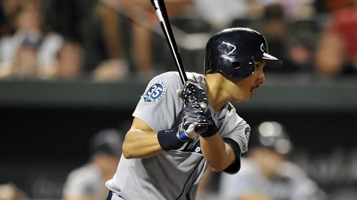 Seattle Mariners shortstop Munenori Kawasaki (61) hits a one-run RBI single in the eighth inning against the Baltimore Orioles at Oriole Park at Camden Yards. The Orioles defeated the Mariners 3 - 1 in 2012.