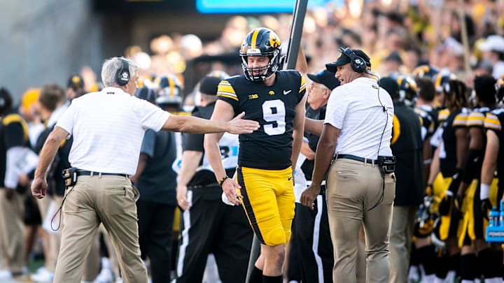 Iowa's Tory Taylor (9) gets a high-five from Iowa head coach Kirk Ferentz, left, while celebrating a punt with special teams coordinator LeVar Woods during a NCAA non-conference football game against Colorado State, Saturday, Sept. 25, 2021, at Kinnick Stadium in Iowa City, Iowa.