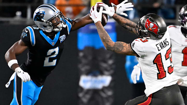 Dec 1, 2024; Charlotte, North Carolina, USA;  Tampa Bay Buccaneers wide receiver Mike Evans (13) catches the ball as Carolina Panthers cornerback Michael Jackson (2) defends in overtime at Bank of America Stadium.  