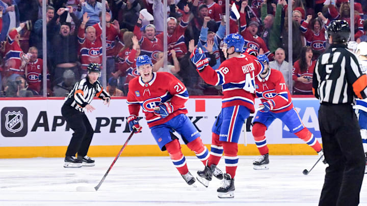 Apr 24, 2026; Montreal, Quebec, CAN; Montreal Canadiens defenseman Lane Hutson (48) celebrates with teammates including defenseman Kaiden Guhle (21) after scoring the winning goal against the Tampa Bay Lightning during the overtime period in game three of the first round of the 2026 Stanley Cup Playoffs at the Bell Centre. Mandatory Credit: Eric Bolte-Imagn Images