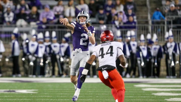 Nov 23, 2024; Manhattan, Kansas, USA; Kansas State Wildcats quarterback Avery Johnson (2) passes the ball against Cincinnati Bearcats linebacker Montay Weedon (44) during the second quarter at Bill Snyder Family Football Stadium. Mandatory Credit: Scott Sewell-Imagn Images Nov 23, 2024; Manhattan, Kansas, USA; Kansas State Wildcats quarterback Avery Johnson (2) passes the ball against Cincinnati Bearcats linebacker Montay Weedon (44) during the second quarter at Bill Snyder Family Football Stadium. Mandatory Credit: Scott Sewell-Imagn Images