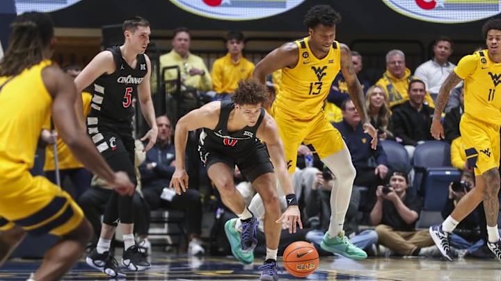 Feb 19, 2025; Morgantown, West Virginia, USA; Cincinnati Bearcats guard Dan Skillings Jr. (0) grabs a loose ball during the second half against the West Virginia Mountaineers at WVU Coliseum. Mandatory Credit: Ben Queen-Imagn Images Feb 19, 2025; Morgantown, West Virginia, USA; Cincinnati Bearcats guard Dan Skillings Jr. (0) grabs a loose ball during the second half against the West Virginia Mountaineers at WVU Coliseum. Mandatory Credit: Ben Queen-Imagn Images