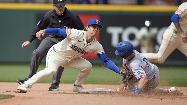 Aug 3, 2025; Seattle, Washington, USA; Seattle Mariners second baseman Cole Young (2) tags Texas Rangers outfielder Sam Haggerty (0) out at second on a steal attempt during the ninth inning at T-Mobile Park. Mandatory Credit: John Froschauer-Imagn Images Aug 3, 2025; Seattle, Washington, USA; Seattle Mariners second baseman Cole Young (2) tags Texas Rangers outfielder Sam Haggerty (0) out at second on a steal attempt during the ninth inning at T-Mobile Park. Mandatory Credit: John Froschauer-Imagn Images
