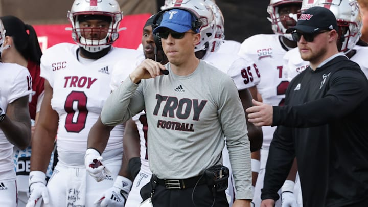 Sep 17, 2022; Boone, North Carolina, USA; Troy Trojans defensive coordinator Shiel Wood (middle) watches the action against the Appalachian State Mountaineers during the second half at Kidd Brewer Stadium. Mandatory Credit: Reinhold Matay-Imagn Images