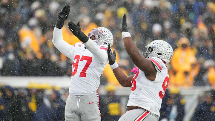 Ohio State Buckeyes defensive end Kenyatta Jackson Jr. (97) celebrates a sack of Michigan Wolverines quarterback Bryce Underwood (19) with defensive tackle Kayden McDonald (98) during the NCAA football game at Michigan Stadium in Ann Arbor, Mich. on Nov. 29, 2025. Ohio State won 27-9. Ohio State Buckeyes defensive end Kenyatta Jackson Jr. (97) celebrates a sack of Michigan Wolverines quarterback Bryce Underwood (19) with defensive tackle Kayden McDonald (98) during the NCAA football game at Michigan Stadium in Ann Arbor, Mich. on Nov. 29, 2025. Ohio State won 27-9.