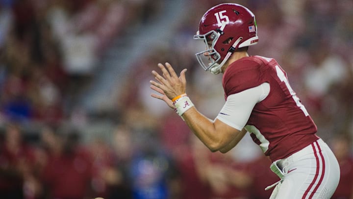 Aug 31, 2024; Tuscaloosa, Alabama, USA;  Alabama Crimson Tide quarterback Ty Simpson (15) reaches out for a snap during the fourth quarter at Bryant-Denny Stadium. Mandatory Credit: Will McLelland-Imagn Images