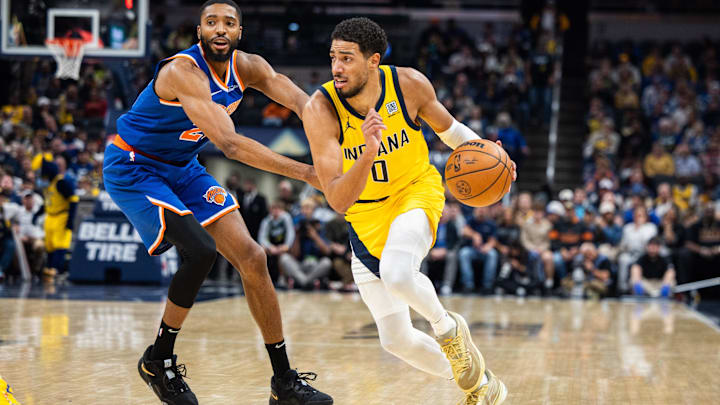 Nov 10, 2024; Indianapolis, Indiana, USA; Indiana Pacers guard Tyrese Haliburton (0) dribbles the ball while New York Knicks forward Mikal Bridges (25) defends in the first quarter at Gainbridge Fieldhouse. Mandatory Credit: Trevor Ruszkowski-Imagn Images