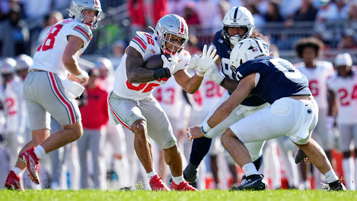 Ohio State Buckeyes running back TreVeyon Henderson (32) tries to elude Penn State Nittany Lions linebacker Dominic DeLuca (0)