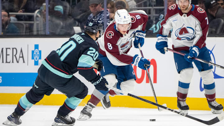 Oct 22, 2024; Seattle, Washington, USA;  Colorado Avalanche defenseman Cale Makar (8) skates against Seattle Kraken forward Eeli Tolvanen (20) during the first period at Climate Pledge Arena. Mandatory Credit: Stephen Brashear-Imagn Images