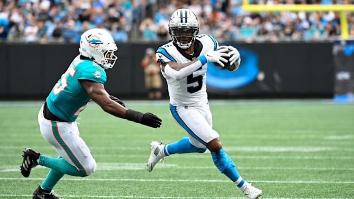 Oct 5, 2025; Charlotte, North Carolina, USA; Carolina Panthers running back Rico Dowdle (5) with the ball as Miami Dolphins linebacker Tyrel Dodson (25) defends in the second quarter at Bank of America Stadium. Mandatory Credit: Bob Donnan-Imagn Images