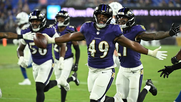 Aug 7, 2025; Baltimore, Maryland, USA; Baltimore Ravens linebacker Jay Higgins IV (49) celebrates after an interception against the Indianapolis Colts during the fourth quarter at M&T Bank Stadium. Mandatory Credit: Rafael Suanes-Imagn Images