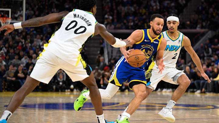 Dec 23, 2024; San Francisco, California, USA; Golden State Warriors guard Stephen Curry (30) drives to the basket against Indiana Pacers guard Bennedict Mathurin (00) and guard Andrew Nembhard (2) in the fourth quarter at Chase Center. Mandatory Credit: Eakin Howard-Imagn Images
