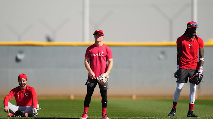 Cincinnati Reds shortstop Matt McLain (9) fields groundballs with Cincinnati Reds second baseman Jonathan India (6), left, and Cincinnati Reds third baseman Elly De La Cruz (44), right, during spring training workouts, Wednesday, Feb. 14, 2024, at the team   s spring training facility in Goodyear, Ariz.
