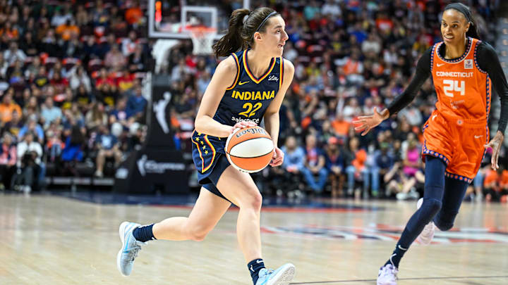 Sep 22, 2024; Uncasville, Connecticut, USA; Indiana Fever guard Caitlin Clark (22) dribbles the ball chased by Connecticut Sun forward DeWanna Bonner (24) in the first quarterduring game one of the first round of the 2024 WNBA Playoffs at Mohegan Sun Arena. Mandatory Credit: Mark Smith-Imagn Images