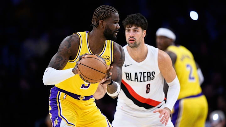 Oct 27, 2025; Los Angeles, California, USA; Los Angeles Lakers center Deandre Ayton (5) looks to pass the ball while under pressure from Portland Trail Blazers forward Deni Avdija (8) during the first half at Crypto.com Arena. Mandatory Credit: William Liang-Imagn Images