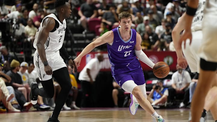 Jul 14, 2025; Las Vegas, NV, USA;  Utah Jazz forward Kyle Filipowski (22) dribbles the ball against San Antonio Spurs forward Osayi Osifo (26) during the first half of a NBA basketball game at Thomas & Mack Center. Mandatory Credit: Lucas Peltier-Imagn Images