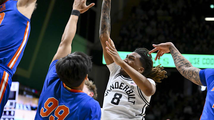Jan 17, 2026; Nashville, Tennessee, USA;  Florida Gators center Mic Handlogten (34) blocks the shot of Vanderbilt Commodores guard Tyler Harris (8) during the second half at Memorial Gymnasium. Mandatory Credit: Steve Roberts-Imagn Images