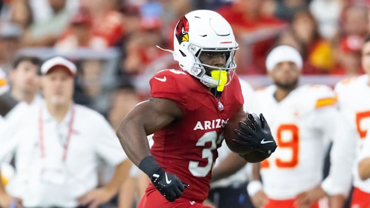 Aug 9, 2025; Glendale, Arizona, USA; Arizona Cardinals running back Trey Benson (33) against the Kansas City Chiefs during a preseason NFL game at State Farm Stadium. Mandatory Credit: Mark J. Rebilas-Imagn Images