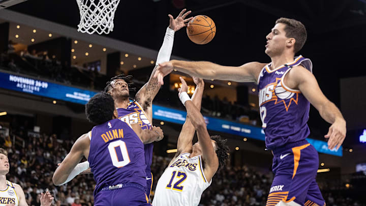 Oct 6, 2024; Palm Desert, California, USA; Phoenix Suns forward Jalen Bridges (15) blocks a shot against the Los Angeles Lakers during the second half at Acrisure Arena. Mandatory Credit: David Frerker-Imagn Images