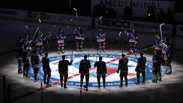 Jan 14, 2021; New York, NY, USA;  New York Rangers players huddle around the center ice logo as they prepare for the home opener against the New York Islanders at Madison Square Garden.  