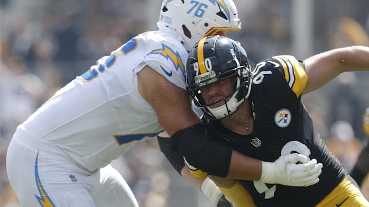 Sep 22, 2024; Pittsburgh, Pennsylvania, USA;  Los Angeles Chargers offensive tackle Joe Alt (76) blocks at the line of scrimmage against Pittsburgh Steelers linebacker T.J. Watt (90) during the first quarter at Acrisure Stadium. Pittsburgh won 20-10. Mandatory Credit: Charles LeClaire-Imagn Images