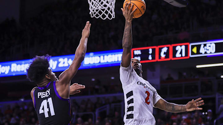 Feb 22, 2025; Cincinnati, Ohio, USA; Cincinnati Bearcats guard Jizzle James (2) shoots against TCU Horned Frogs guard Jace Posey (41) in the first half at Fifth Third Arena. Mandatory Credit: Katie Stratman-Imagn Images