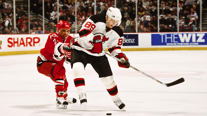 Apr 12, 2001; East Rutherford, NJ, USA; FILE PHOTO; New Jersey Devils right wing Alexander Mogilny (89) in action against Carolina Hurricanes right wing Shane Willis (25) at Continental Airlines Arena. Mandatory Credit: Lou Capozzola-USA TODAY NETWORK Apr 12, 2001; East Rutherford, NJ, USA; FILE PHOTO; New Jersey Devils right wing Alexander Mogilny (89) in action against Carolina Hurricanes right wing Shane Willis (25) at Continental Airlines Arena. Mandatory Credit: Lou Capozzola-USA TODAY NETWORK