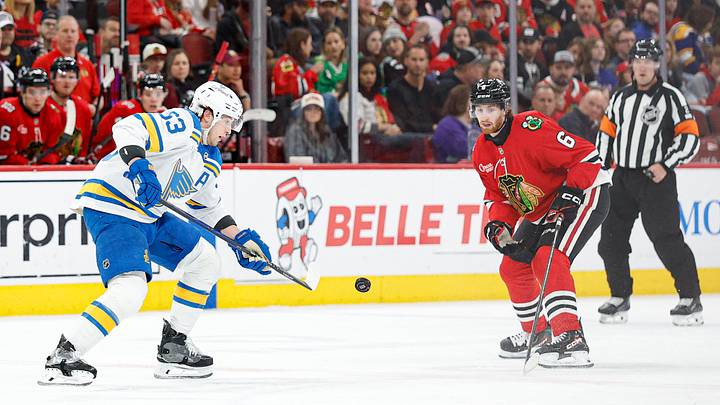Apr 11, 2026; Chicago, Illinois, USA; St. Louis Blues left wing Jake Neighbours (63) passes the puck against the Chicago Blackhawks during the first period at United Center. Mandatory Credit: Kamil Krzaczynski-Imagn Images