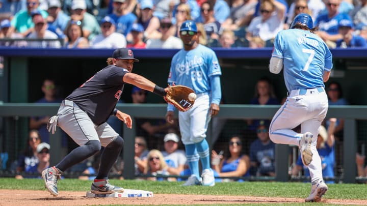 Jun 30, 2024; Kansas City, Missouri, USA; Cleveland Guardians first base Josh Naylor (22) reaches for a throw around Kansas City Royals shortstop Bobby Witt Jr. (7) at first base during the seventh inning at Kauffman Stadium. Mandatory Credit: William Purnell-USA TODAY Sports Jun 30, 2024; Kansas City, Missouri, USA; Cleveland Guardians first base Josh Naylor (22) reaches for a throw around Kansas City Royals shortstop Bobby Witt Jr. (7) at first base during the seventh inning at Kauffman Stadium. Mandatory Credit: William Purnell-USA TODAY Sports