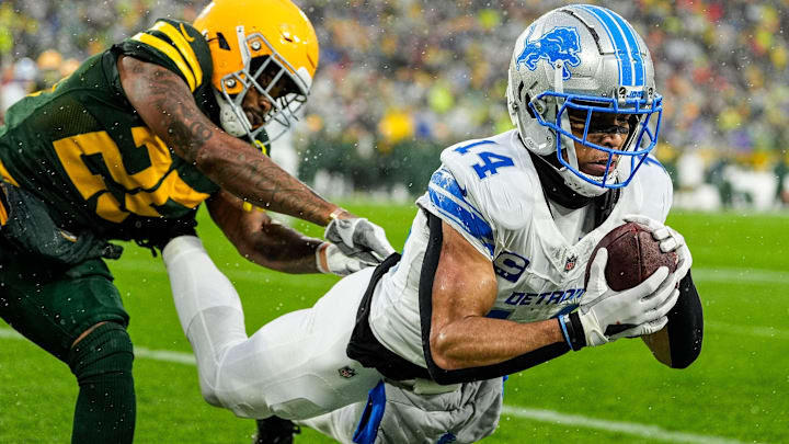 Detroit Lions wide receiver Amon-Ra St. Brown (14) makes a catch for a touchdown against Green Bay Packers cornerback Keisean Nixon (25) during the first half at Lambeau Field in Green Bay, Wis. on Sunday, Nov. 3, 2024.