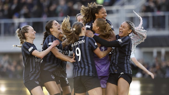 Washington Spirit goalkeeper Aubrey Kingsbury (1) celebrates with defender Tara McKeown (9) and defender Casey Krueger (3) and forward Trinity Rodman (2) after defeating NJ/NY Gotham FC in a penalty kick shoot out in a 2024 NWSL Playoffs semifinal match at Audi Field 