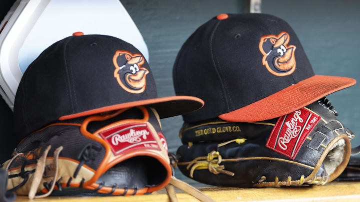 Apr 27, 2023; Detroit, Michigan, USA;  Baltimore Orioles hats and glove sits in dugout in the second inning against the Detroit Tigers at Comerica Park. Mandatory Credit: Rick Osentoski-Imagn Images